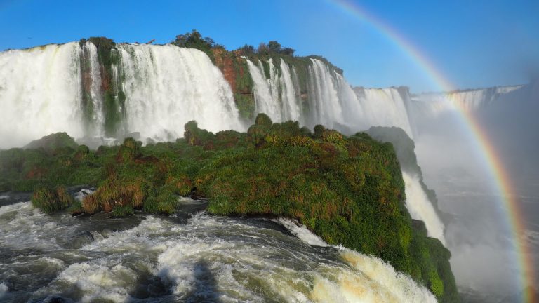 A beautiful scenery of a rainbow over a waterfall in Iguazu National Park, Cataratas, Argentina